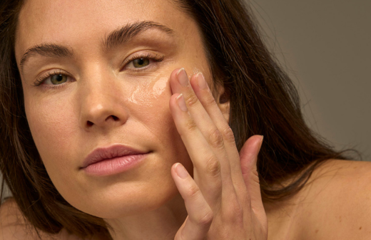 Woman adding Apeer serum to her face 